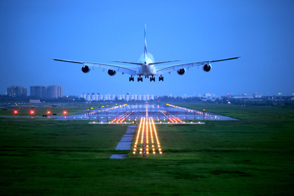 A passenger plane approaches a runway.